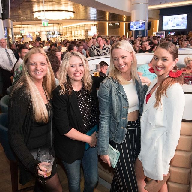 Four women, smiling