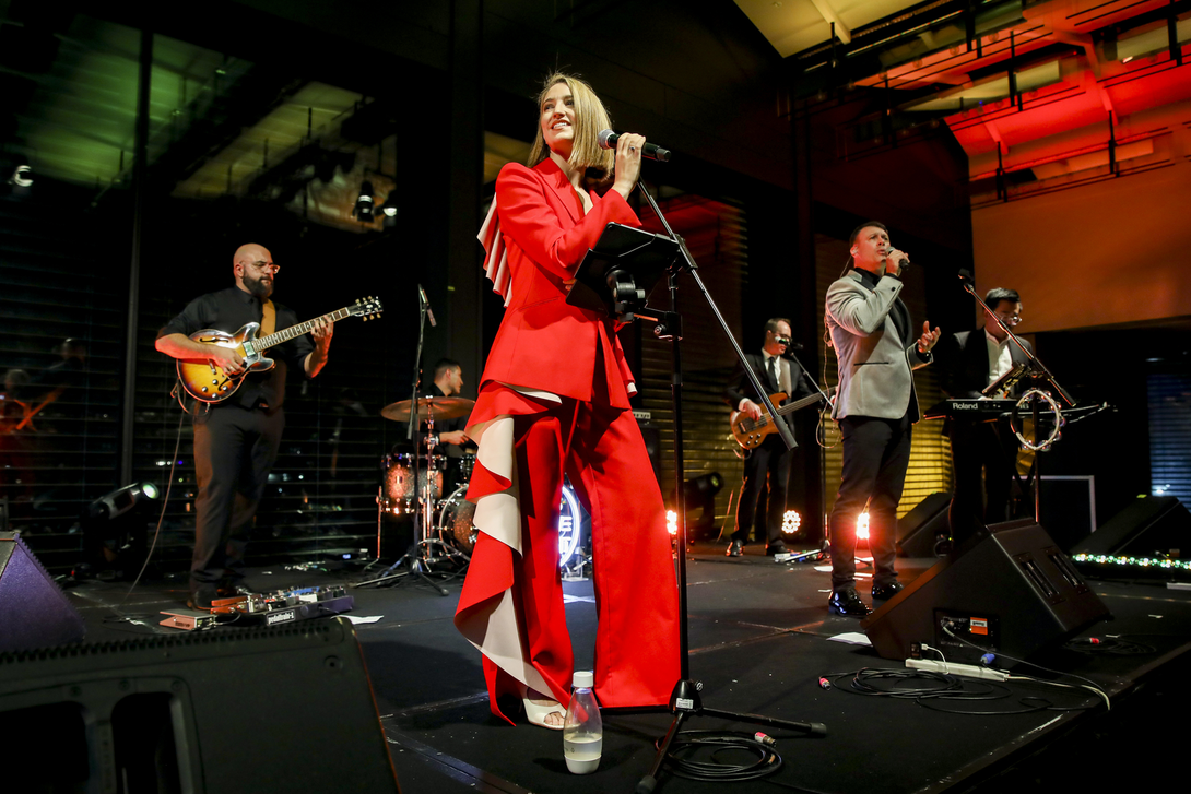 Singing in a red outfit